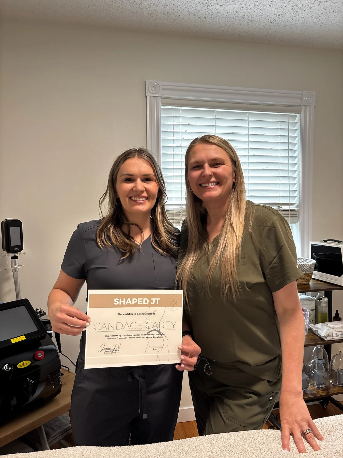 Trisha celebrating a training certificate with a trainee